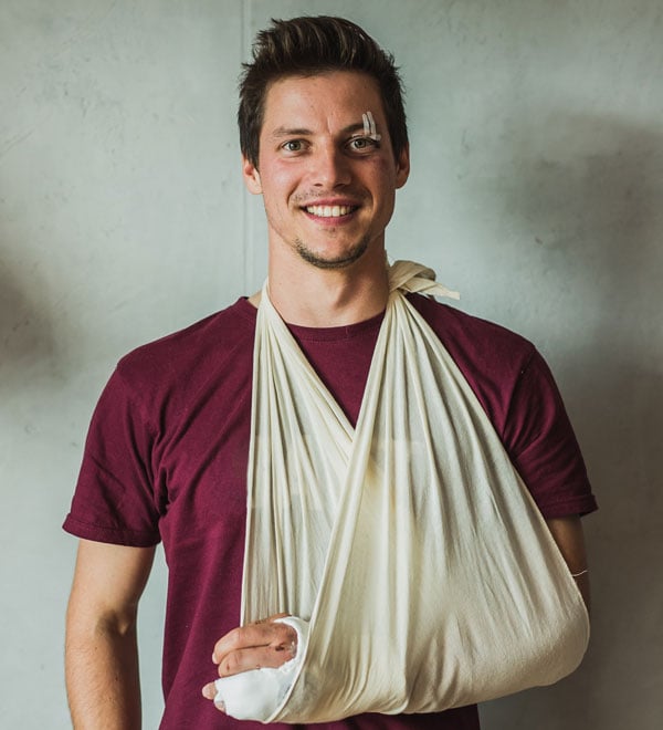 smiling man with arm sling